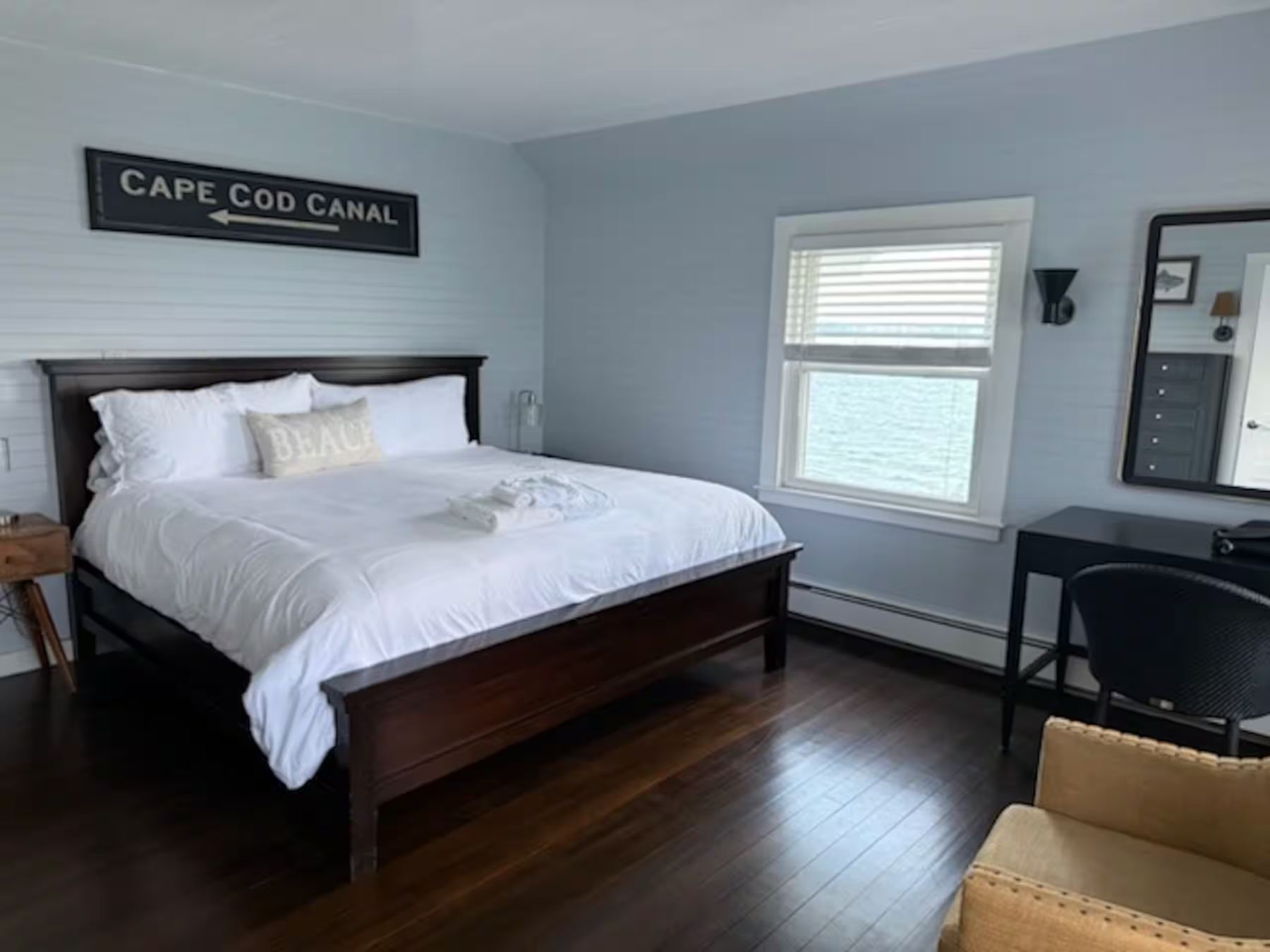 Room 5, a king bed beside a window looking onto the water