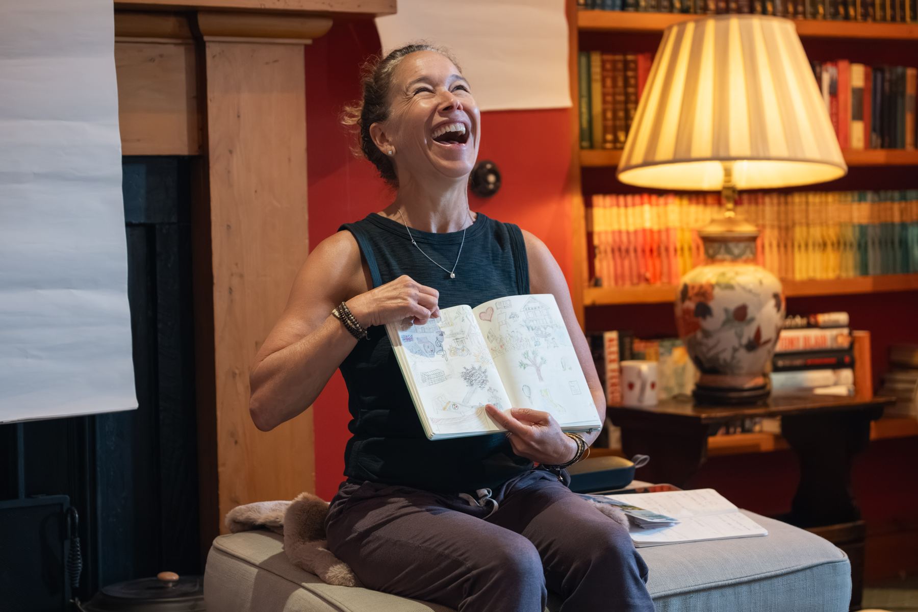 A guest laughing as she shows her sketchbook